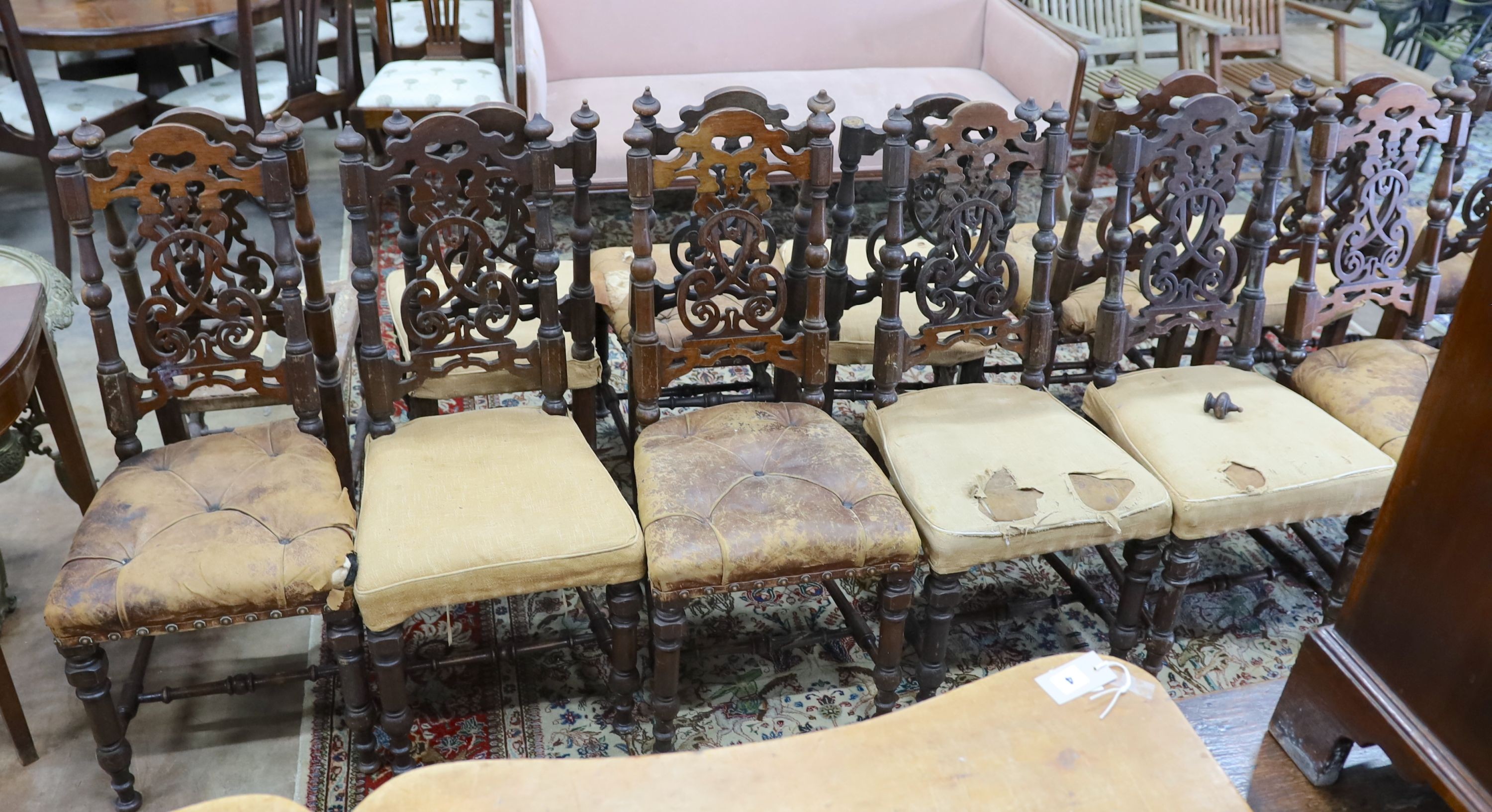 A set of fourteen 19th century Continental carved oak dining chairs